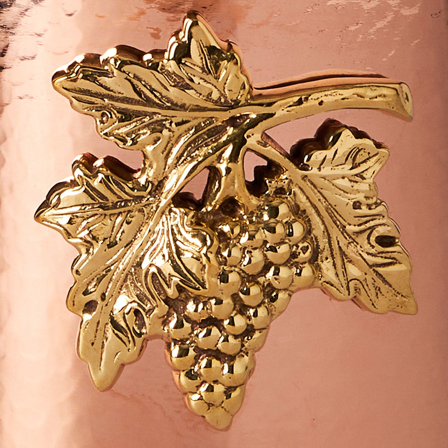 detail of the bronze grape medallioni copper utensil holder