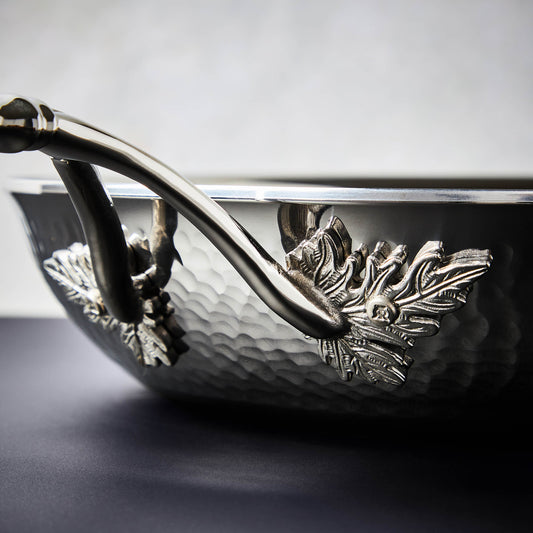 Details of the Opus Prima hammered clad stainless steel pan with decorated silver-plated