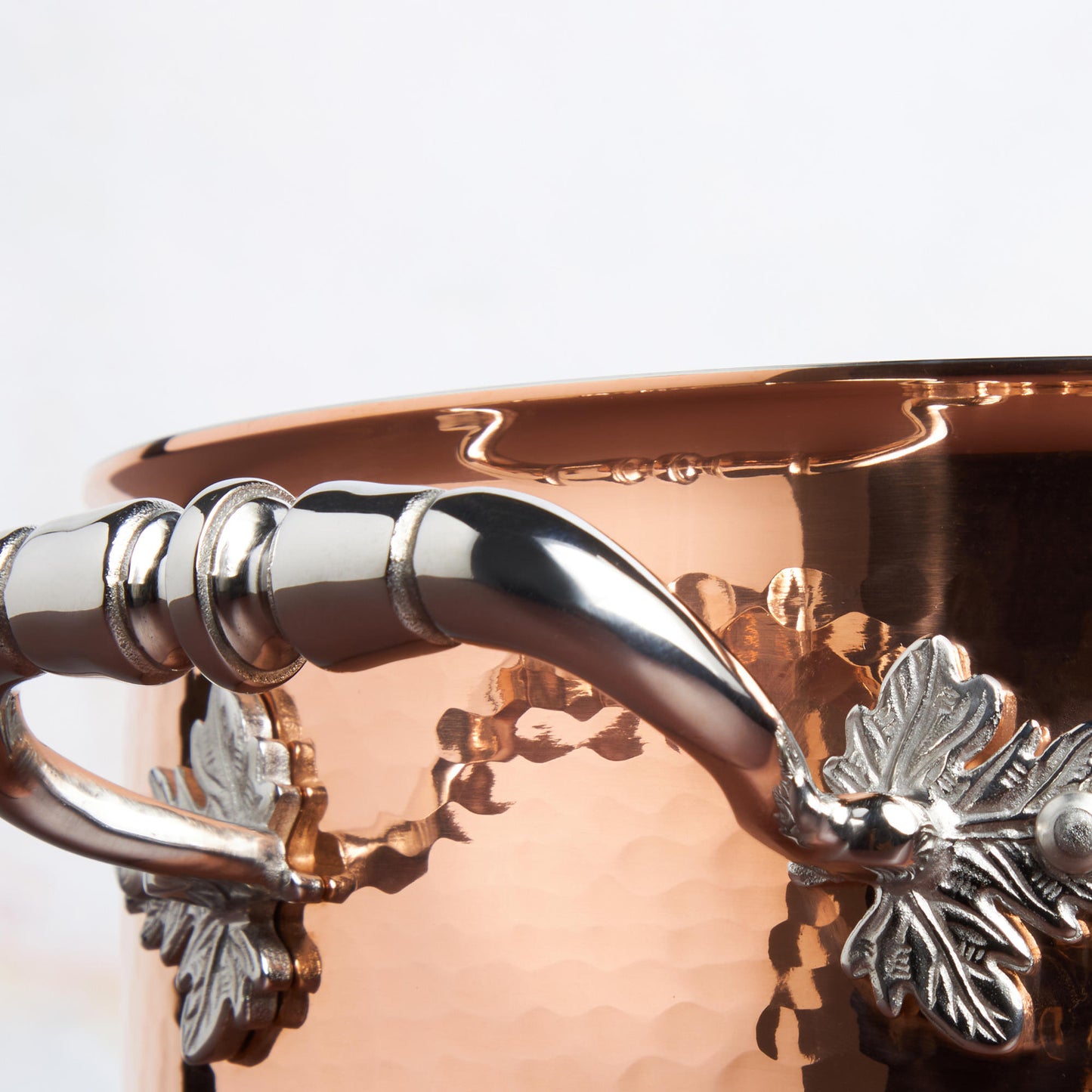 Beautiful stainless steel handle decorated with delicate leaves on Opus Cupra cookware