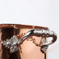 Beautiful stainless steel helper handle decorated with delicate leaves on Opus Cupra cookware