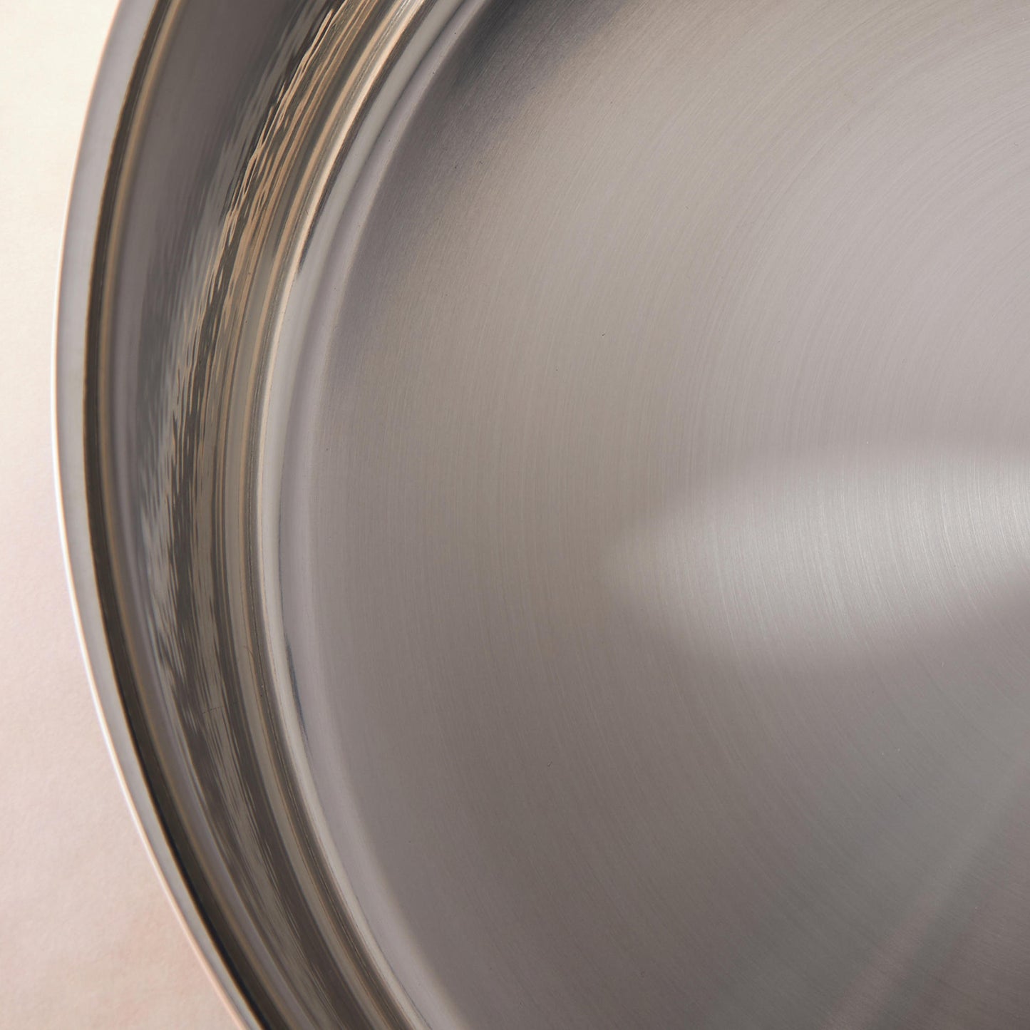 Sunray polished and hammered stainless steel lining in saucepan