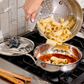 Tomato tuna sauce pasta with rigatoni in an Opus Prima hammered-clad stainless steel chef's pan decorated silver-plated lid knob finial.