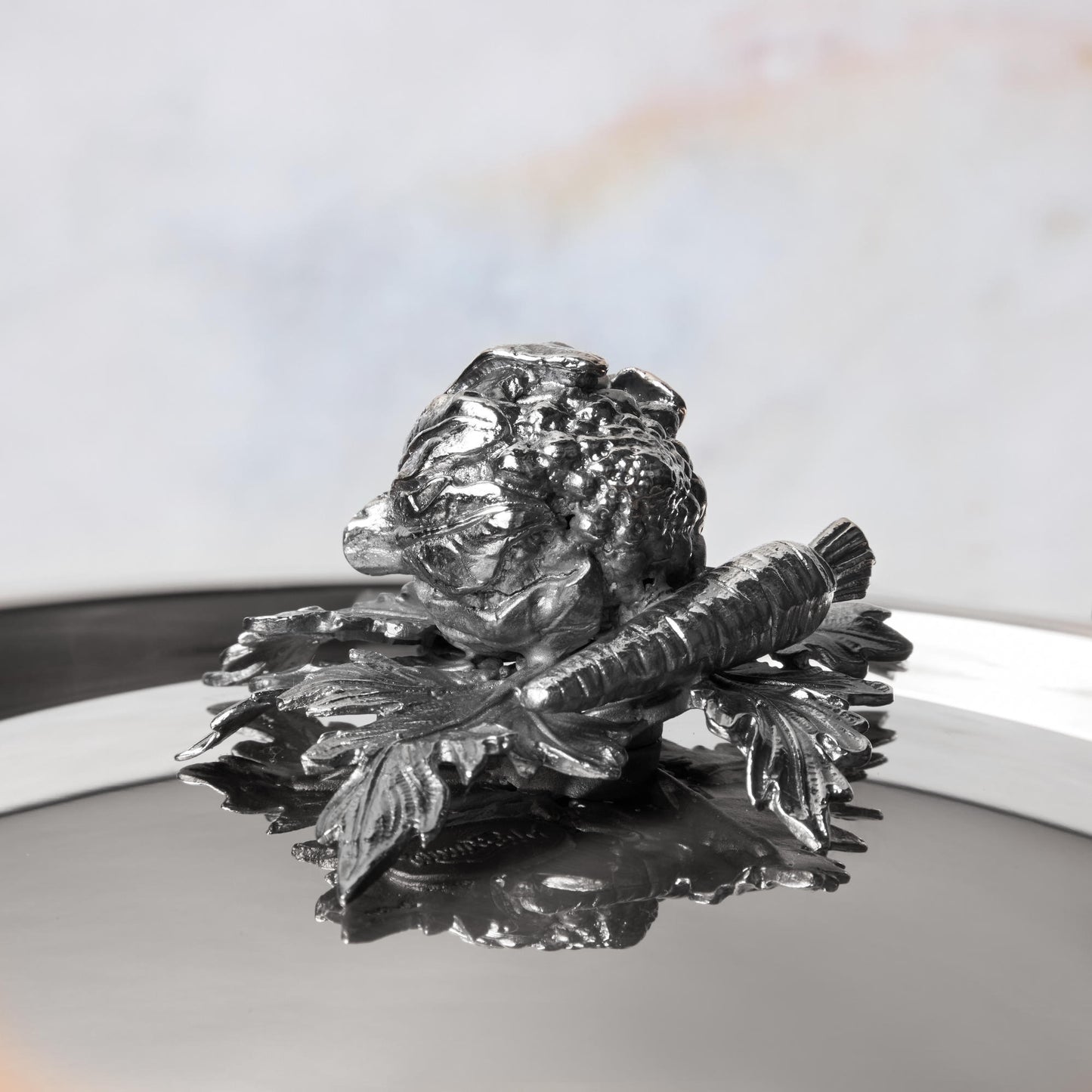 Decorated knob finial representing cauliflower and carrot, cast in solid bronze and silver plated, on Opus Prima stainless steel lid