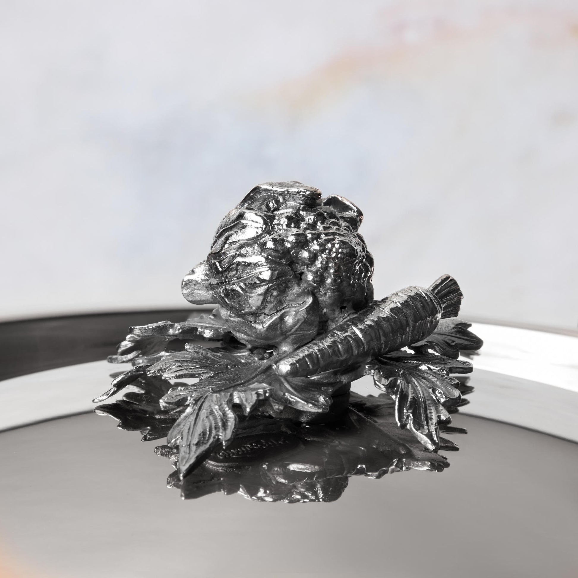Decorated knob finial representing cauliflower and carrot, cast in solid bronze and silver plated, on Opus Prima stainless steel lid