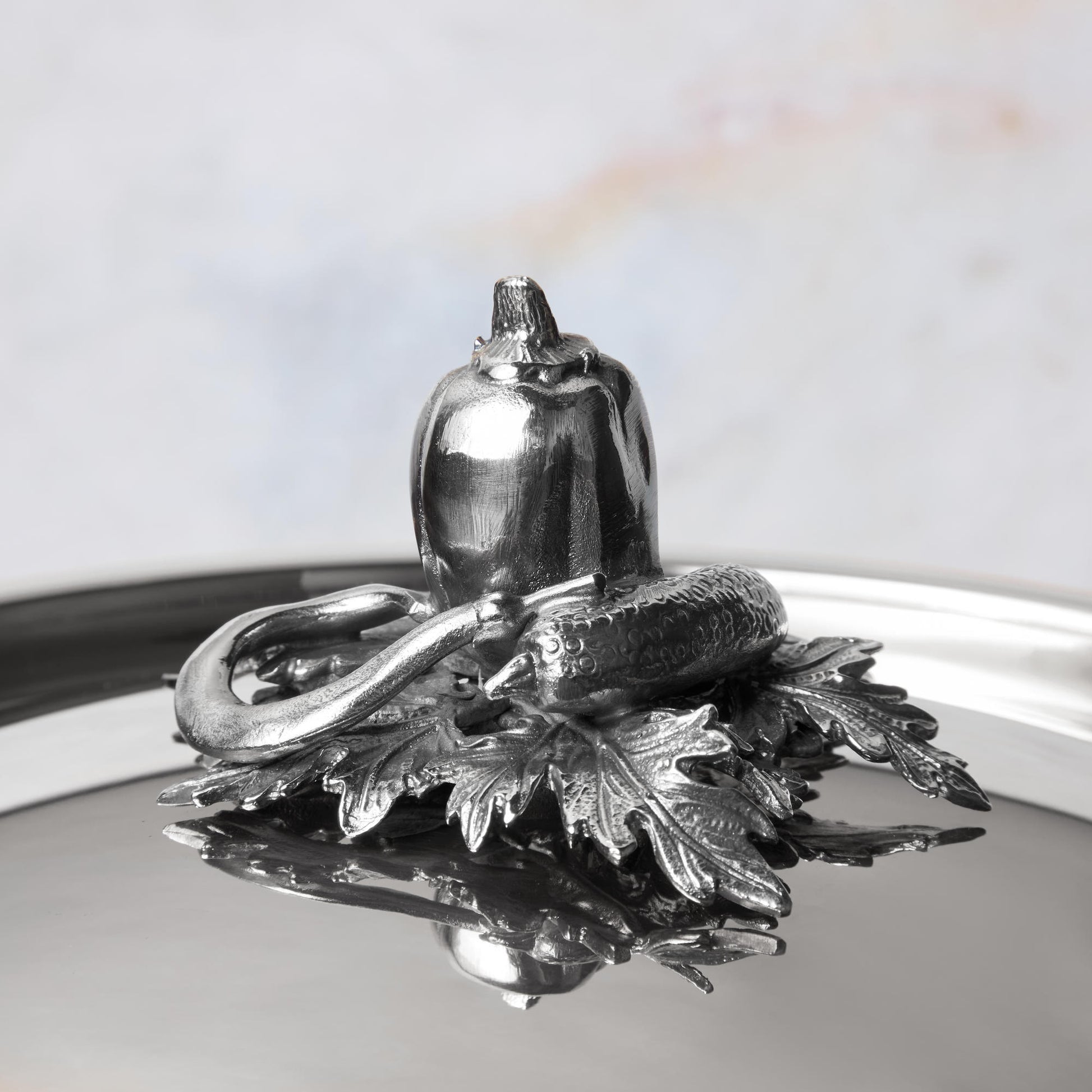 Decorated knob finial representing pepper, cucumber, string bean, cast in solid bronze and silver plated, on Opus Prima stainless steel lid