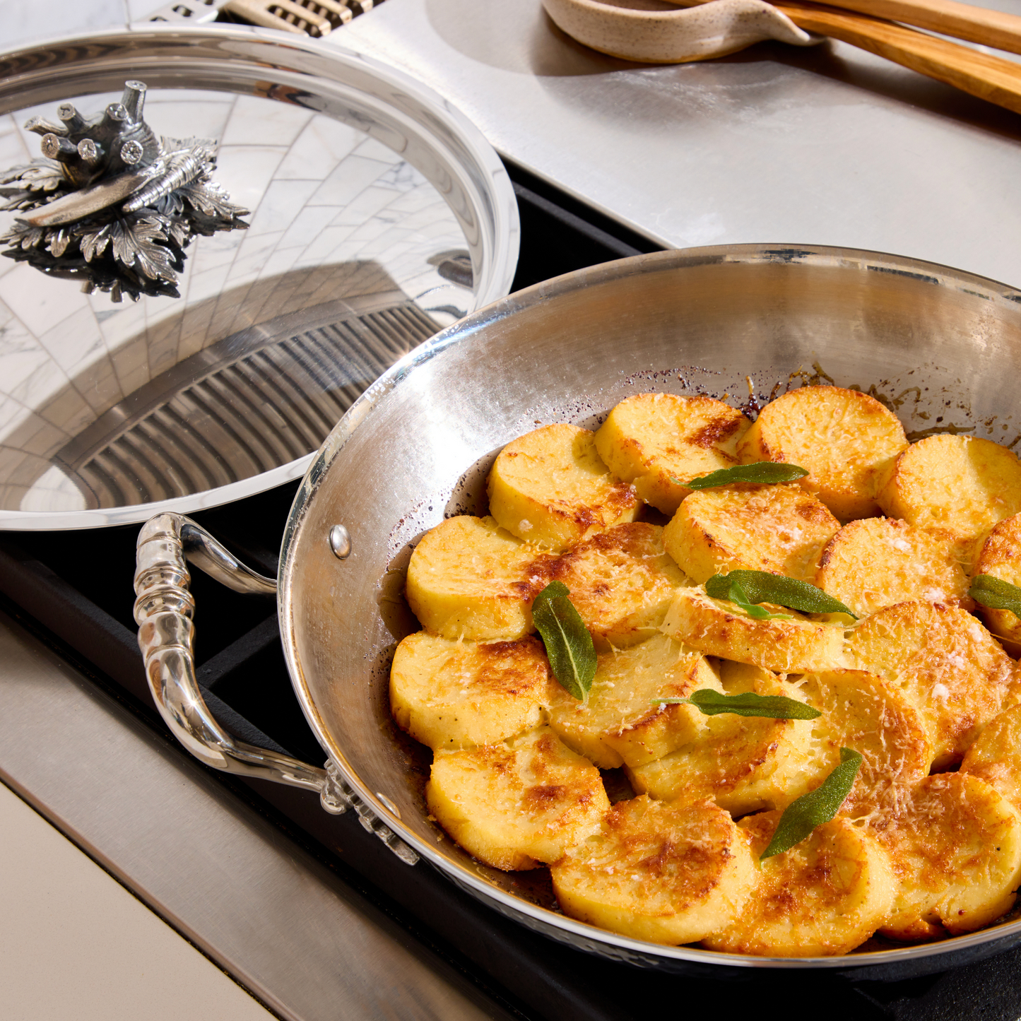 Gnocchi alla romana prepared and served  Opus Prima hammered clad stainless steel gratin with decorated silver-plated lid knob finial 