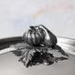Decorated knob finial representing pumpkin and gourd, cast in solid bronze and silver plated, on Opus Prima stainless steel lid
