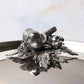 Decorated knob finial representing garlic and pepper, cast in solid bronze and silver plated, on Opus Prima stainless steel lid