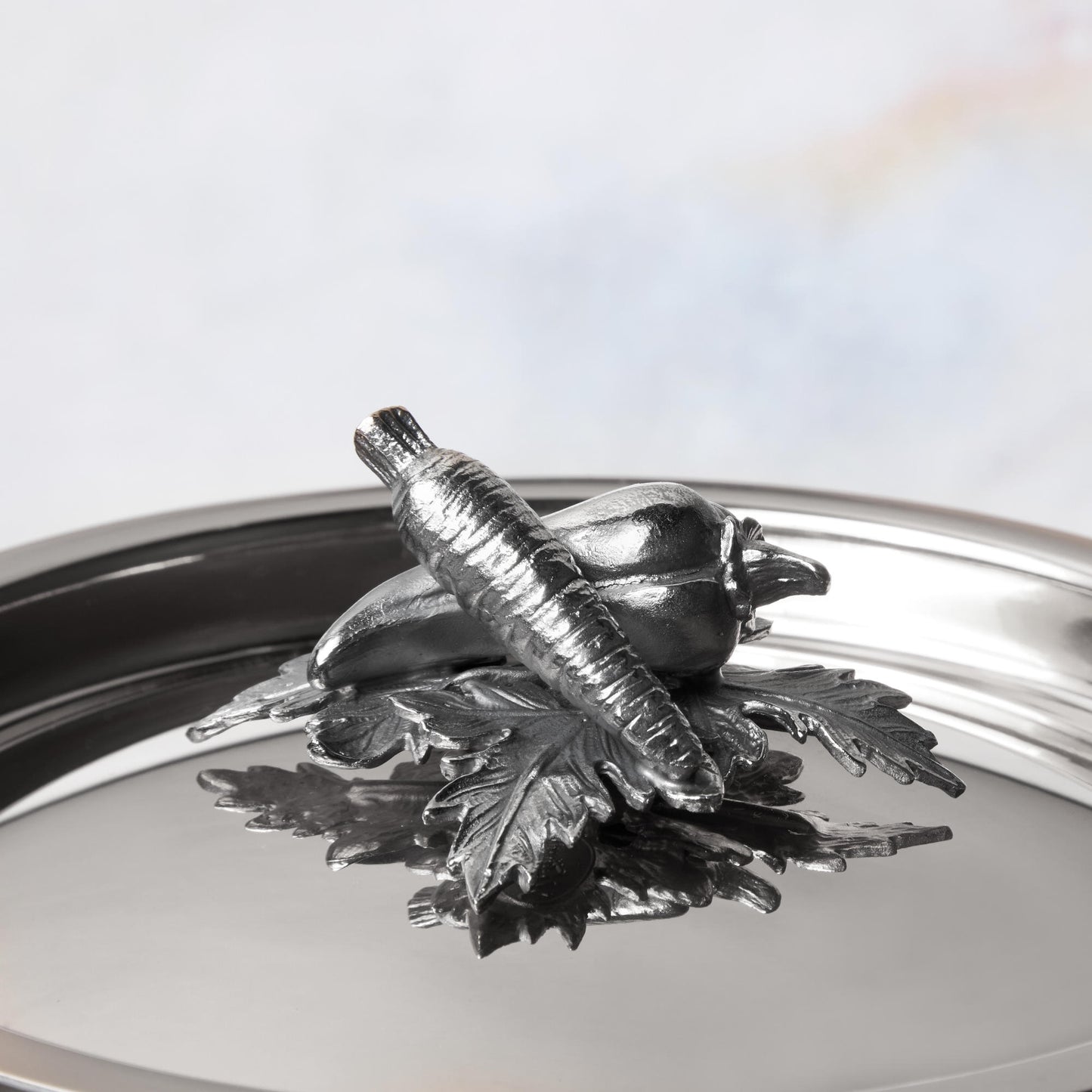 Decorated knob finial representing carrot and pepper, cast in solid bronze and silver plated, on Opus Prima stainless steel lid