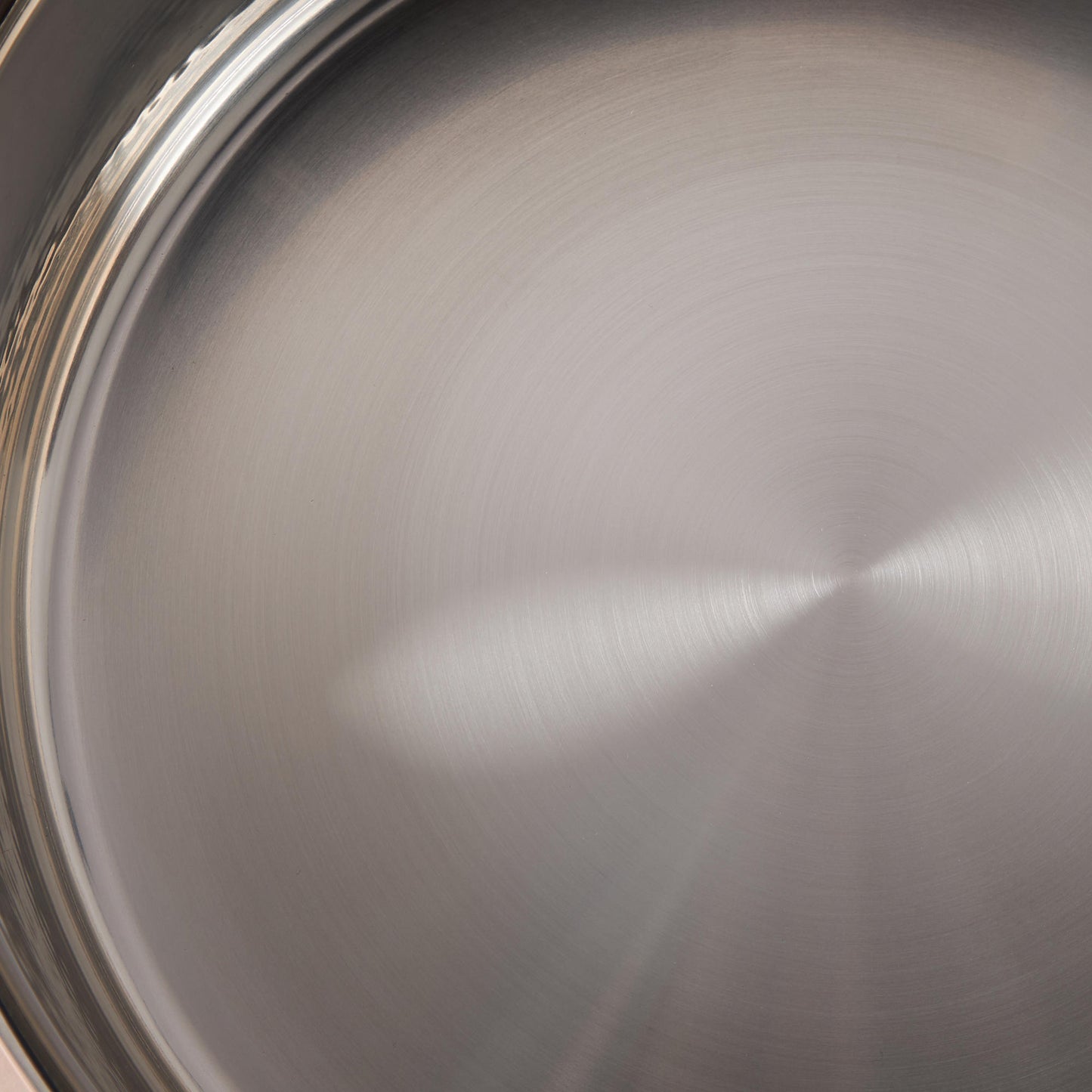 Sunray polished and hammered stainless steel lining in saucepan