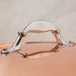 Comfortable lid handle in stainless steel with decorative inlaid copper coin