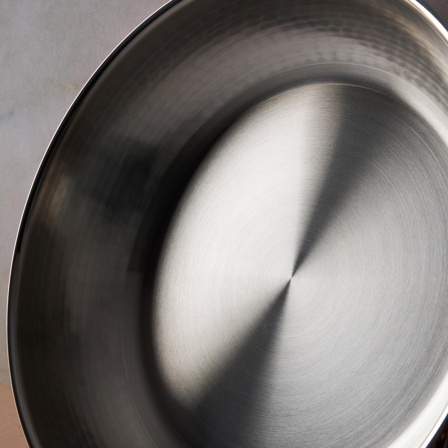 Sunray polished and hammered stainless steel lining in saucepan