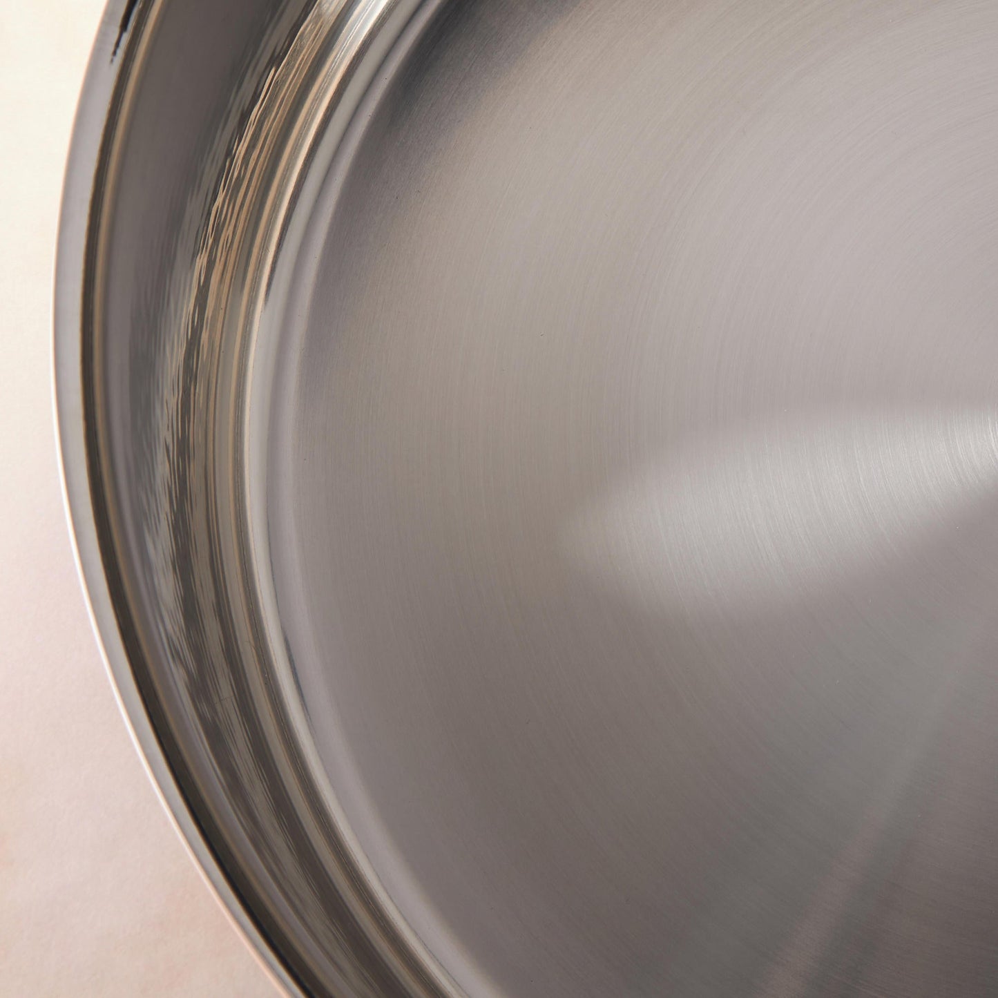 Sunray polished and hammered stainless steel lining in saucepan