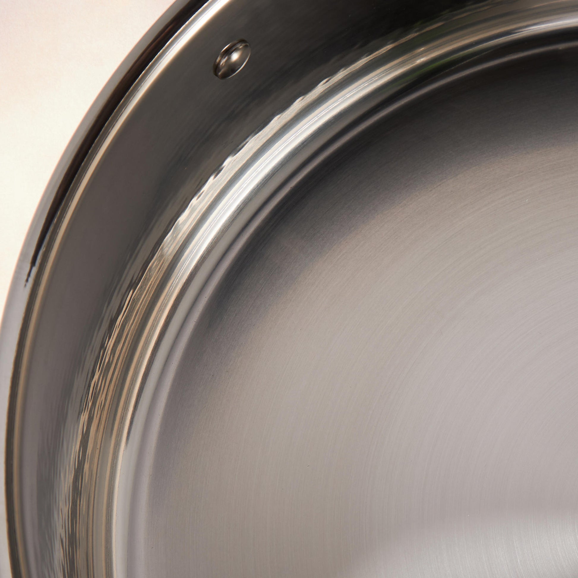Sunray polished and hammered stainless steel lining in saucepan