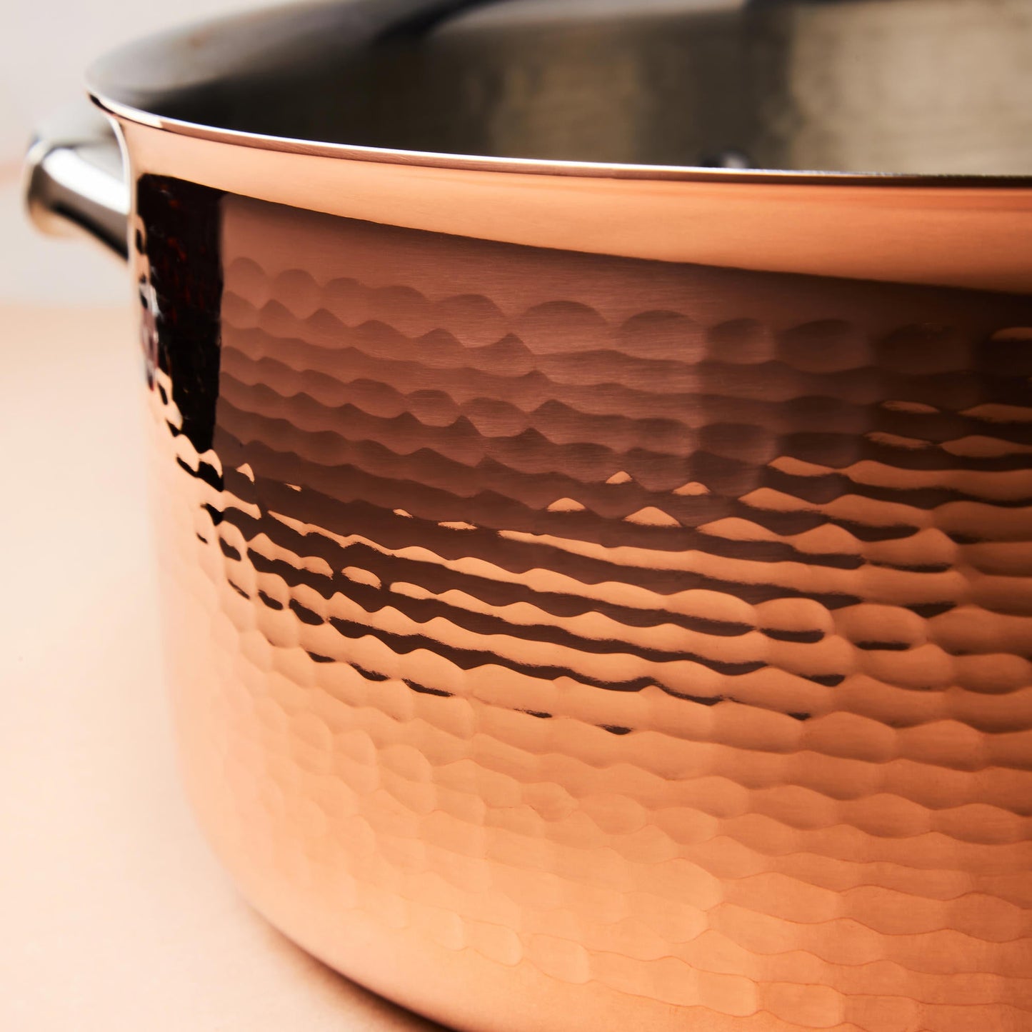 Hammering increases strength and beauty of copper clad with stainless steel cookware