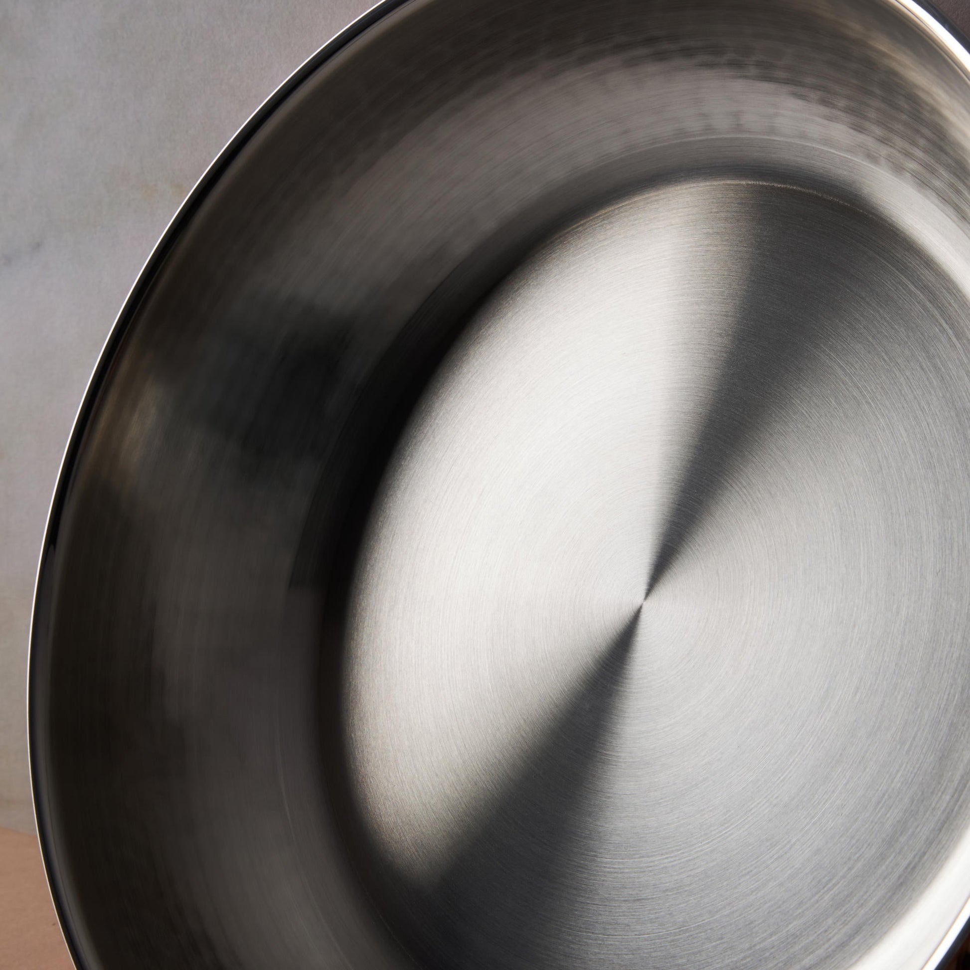 Sunray polished and hammered stainless steel lining in saucepan
