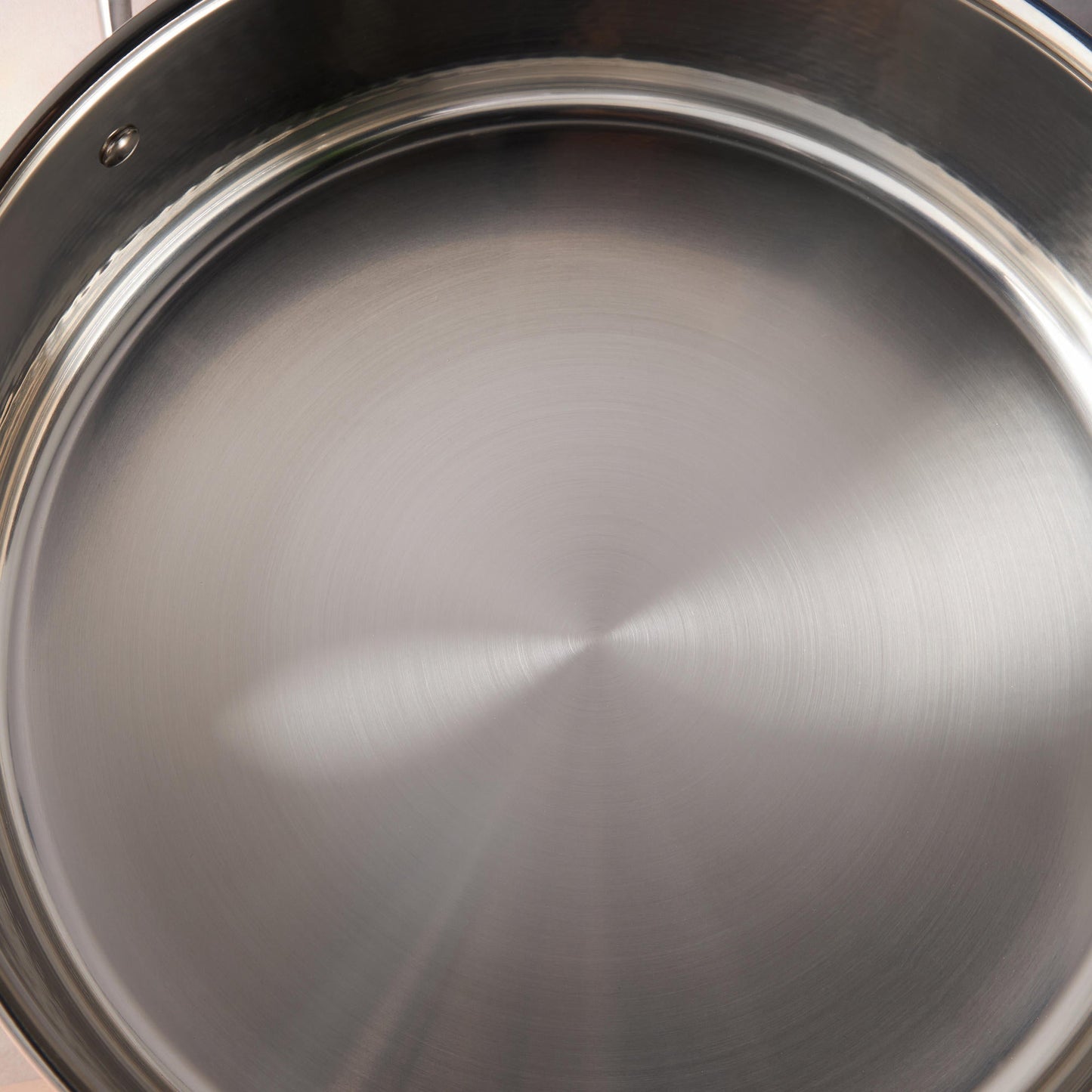 Sunray polished and hammered stainless steel lining in saucepan