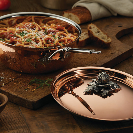 Opus Cupra hammered copper chef pan with stainless steel lining and decorated silver-plated lid knob finial used to serve Italian spaghetti