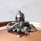 Decorated knob finial representing pepper, cucumber and string bean, cast in solid bronze and silver plated, on Opus Cupra clad copper lid