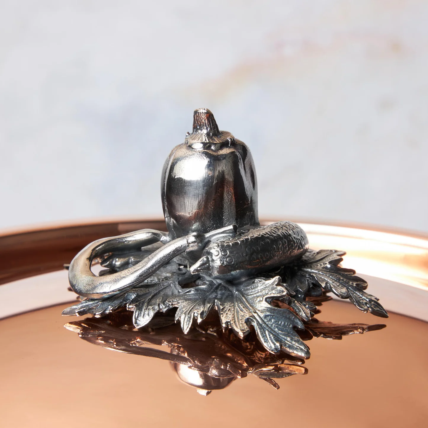 Decorated knob finial representing pepper, cucumber and string bean, cast in solid bronze and silver plated, on Opus Cupra clad copper lid