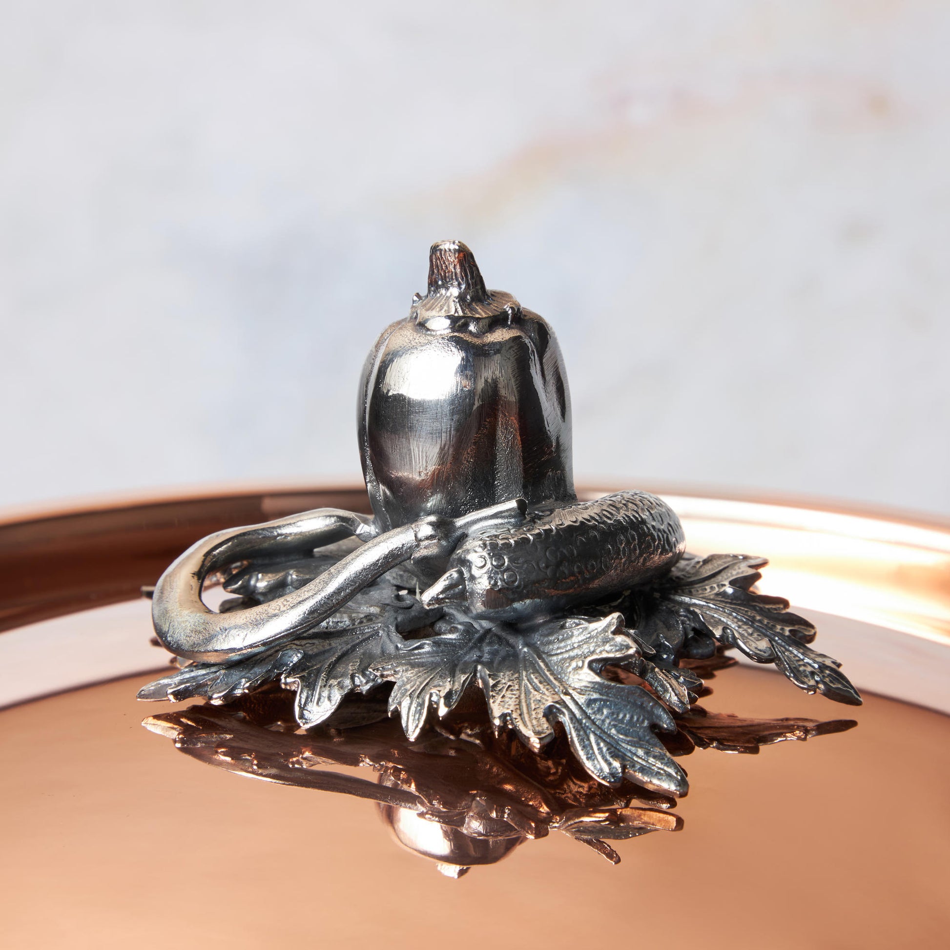 Decorated knob finial representing pepper, cucumber and string bean, cast in solid bronze and silver plated, on Opus Cupra clad copper lid