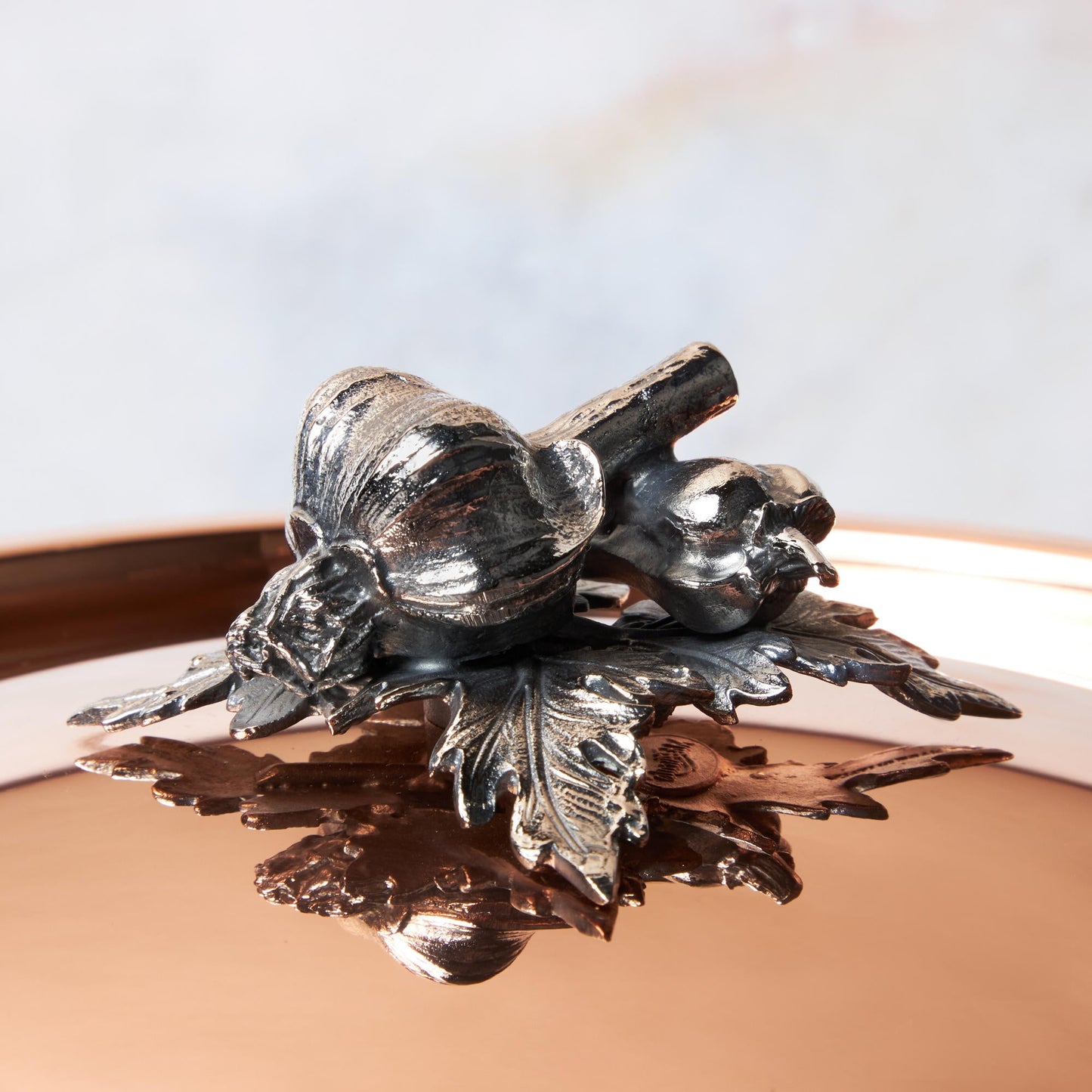 Decorated knob finial representing garlic and pepper, cast in solid bronze and silver plated, on Opus Cupra clad copper lid