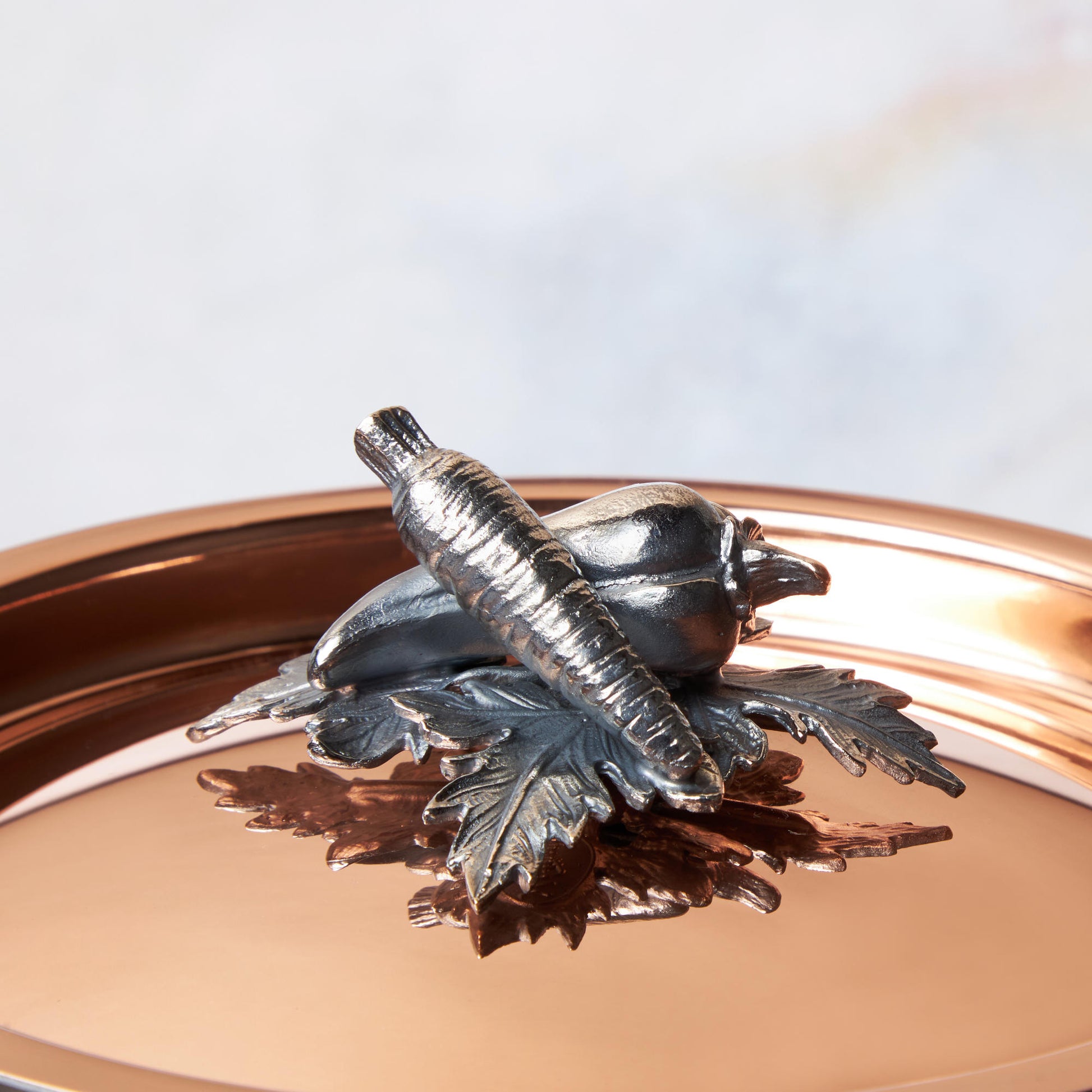 Decorated knob finial representing carrot and pepper  cast in solid bronze and silver plated, on Opus Cupra clad copper lid