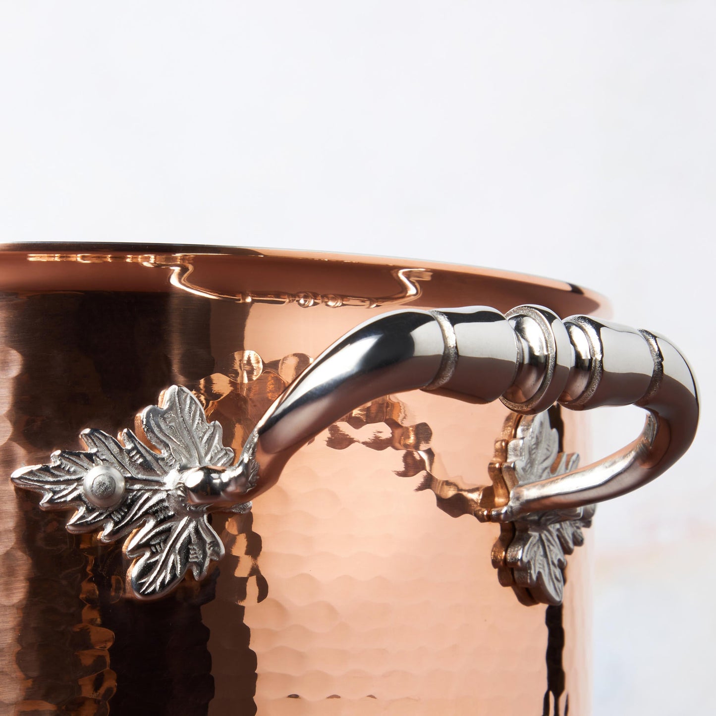 Beautiful stainless steel handle decorated with delicate leaves on Opus Cupra cookware