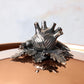 Decorated knob finial representing fennel, carrot and bean, cast in solid bronze and silver plated, on Opus Cupra clad copper lid