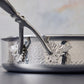 Opus Prima Sauté Pan 3.5qt crafted in hammered stainless steel and decorated with iconic motifs