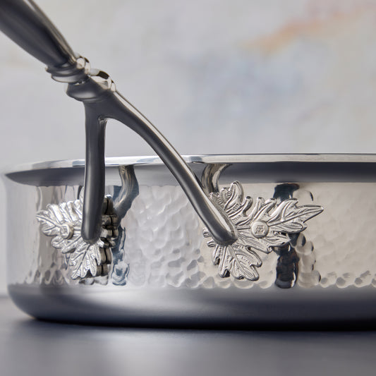 Opus Prima Sauté Pan 3.5qt crafted in hammered stainless steel and decorated with iconic motifs