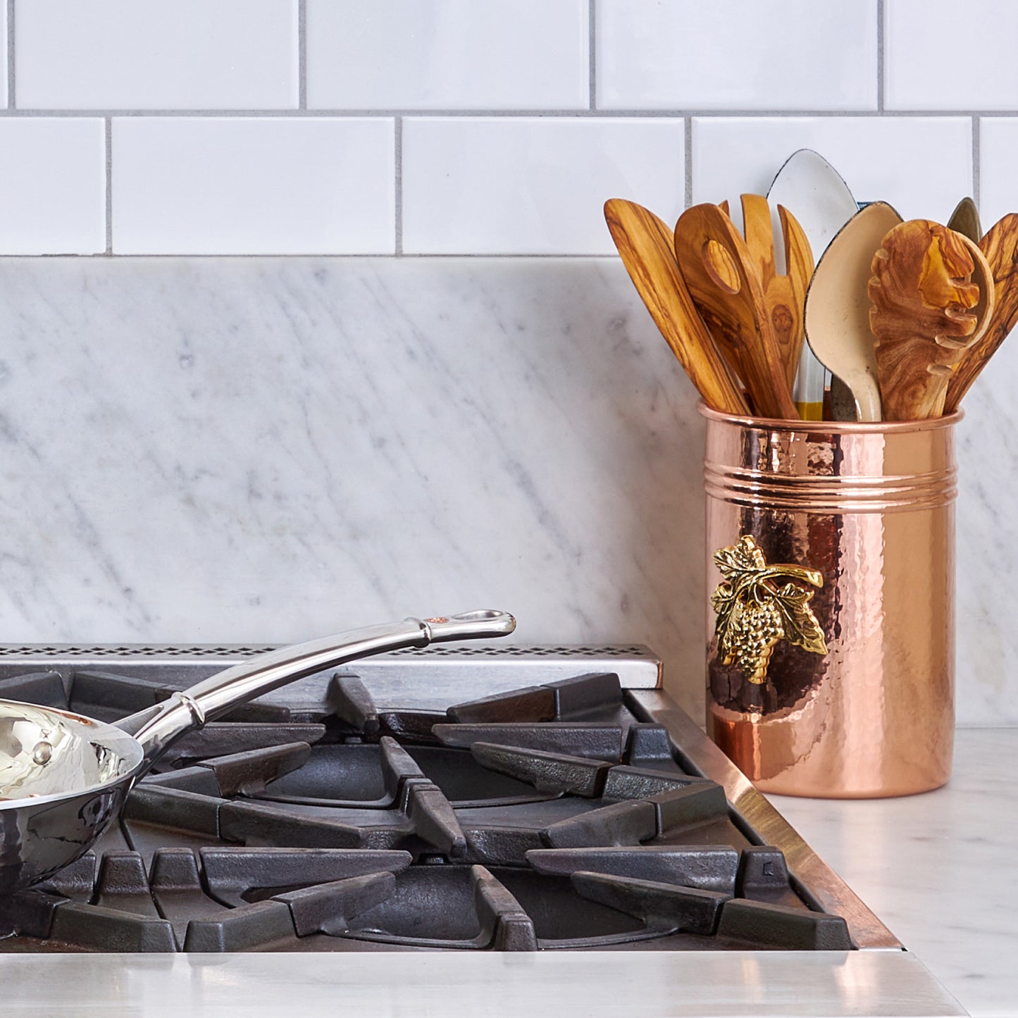 Container for kitchen utensils, made of solid copper, decorated with a bronze plaque depicting grapes,