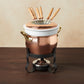 Hammered copper 11 Piece Fondue Michelle Set lined with high purity tin applied by hand over fire and bronze handles, from Glamstore Historia collection. The full set includes: tin-lined copper fondue pot, porcelain insert, decorative wrought iron stand, gel fuel holder, and six fondue forks.