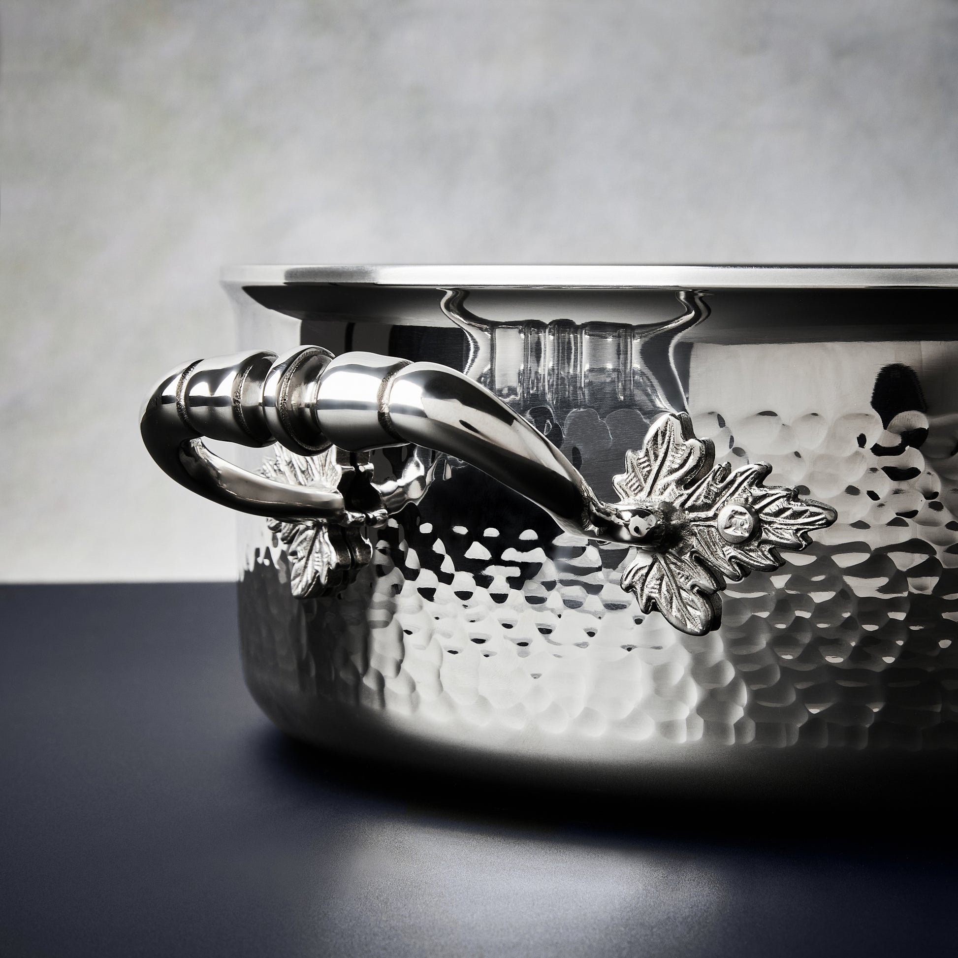 Beautiful stainless steel handle decorated with delicate leaves on Opus Prima cookware