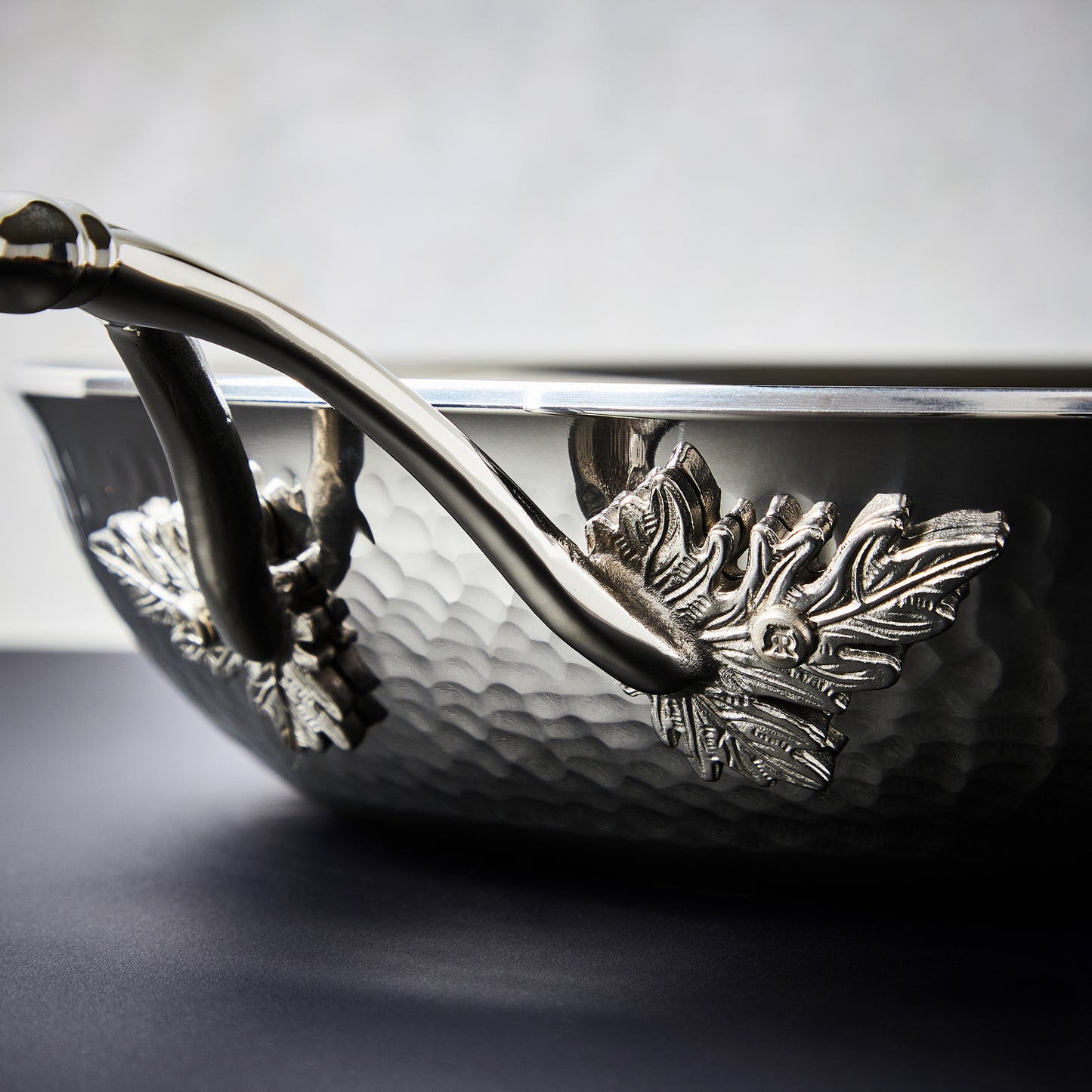 Beautiful clad stainless steel handle decorated with delicate leaves on Opus Prima cookware
