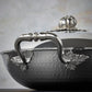 Beautiful stainless steel handle decorated with delicate leaves on Opus Prima cookware