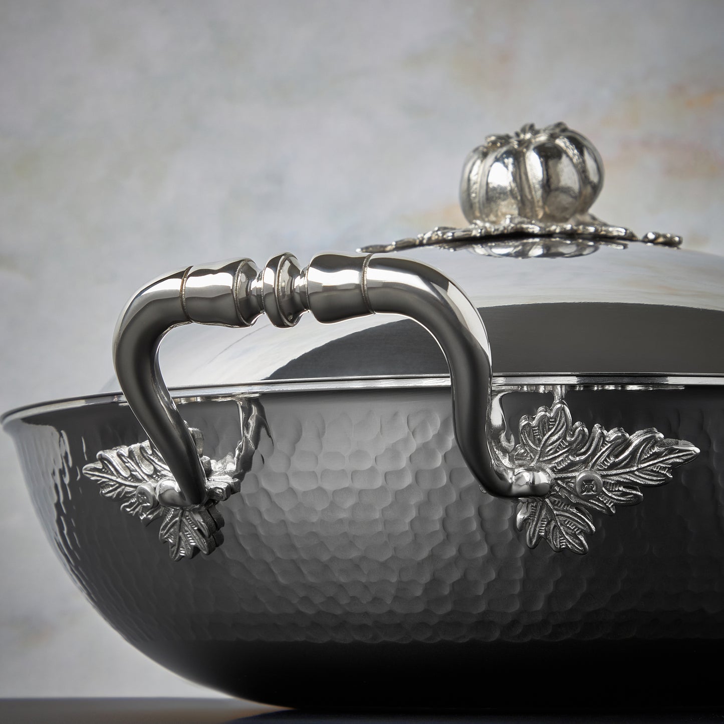 Beautiful stainless steel handle decorated with delicate leaves on Opus Prima cookware