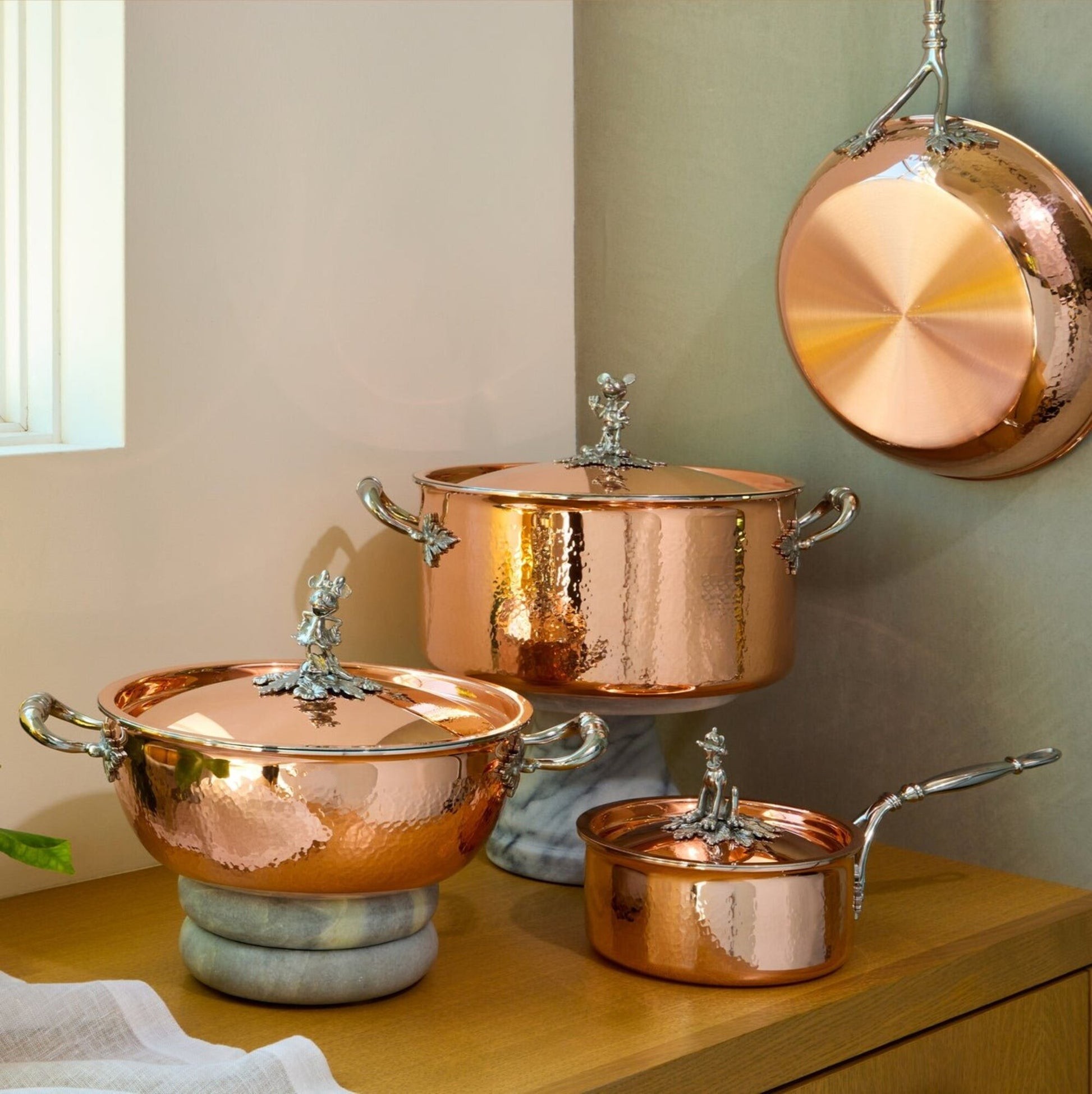 7-piece set  Opus Cupra hammered copper with special edition Disney-inspired knobs in stainless steel featuring Mickey Mouse, Minnie Mouse, and Pluto,