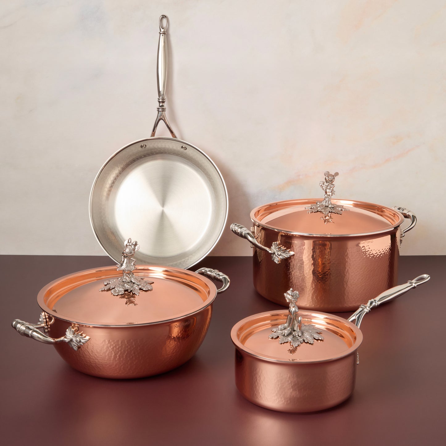 7-piece set  Opus Cupra hammered copper with special edition Disney-inspired knobs in stainless steel featuring Mickey Mouse, Minnie Mouse, and Pluto,