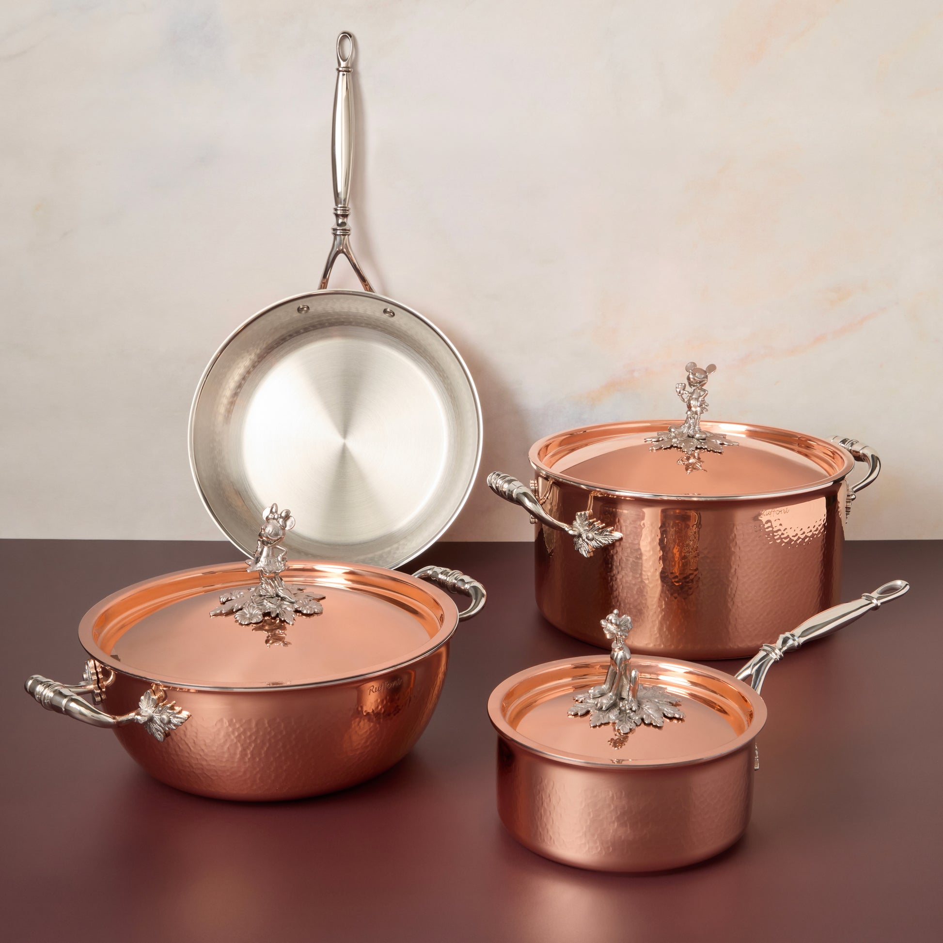 7-piece set  Opus Cupra hammered copper with special edition Disney-inspired knobs in stainless steel featuring Mickey Mouse, Minnie Mouse, and Pluto,
