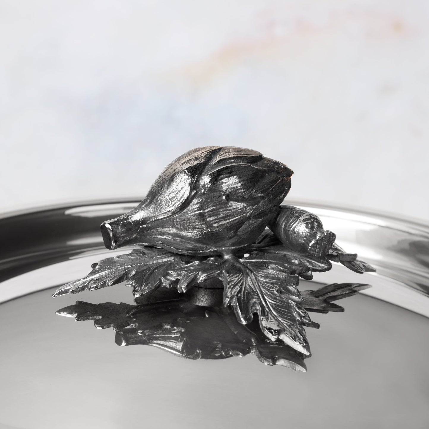 Decorated knob finial representing  artichoke  and carrot, cast in solid bronze and silver plated, on Opus Prima stainless steel lid